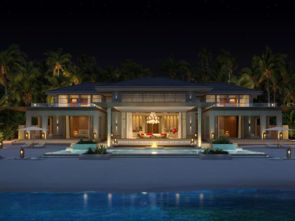 Luxurious beachfront villa at night warm interior lights palm trees central pool and fire pit Propriétés clovis